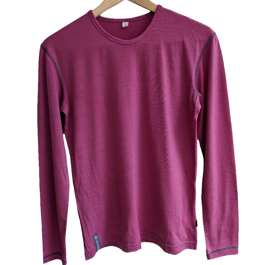 Pink long-sleeve merino top on a wooden hanger against a white background