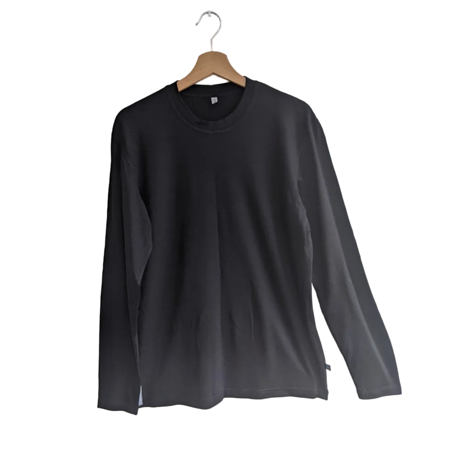 A black long-sleeve Merino Wool crewneck shirt hanging on a wooden hanger against a plain white wall.