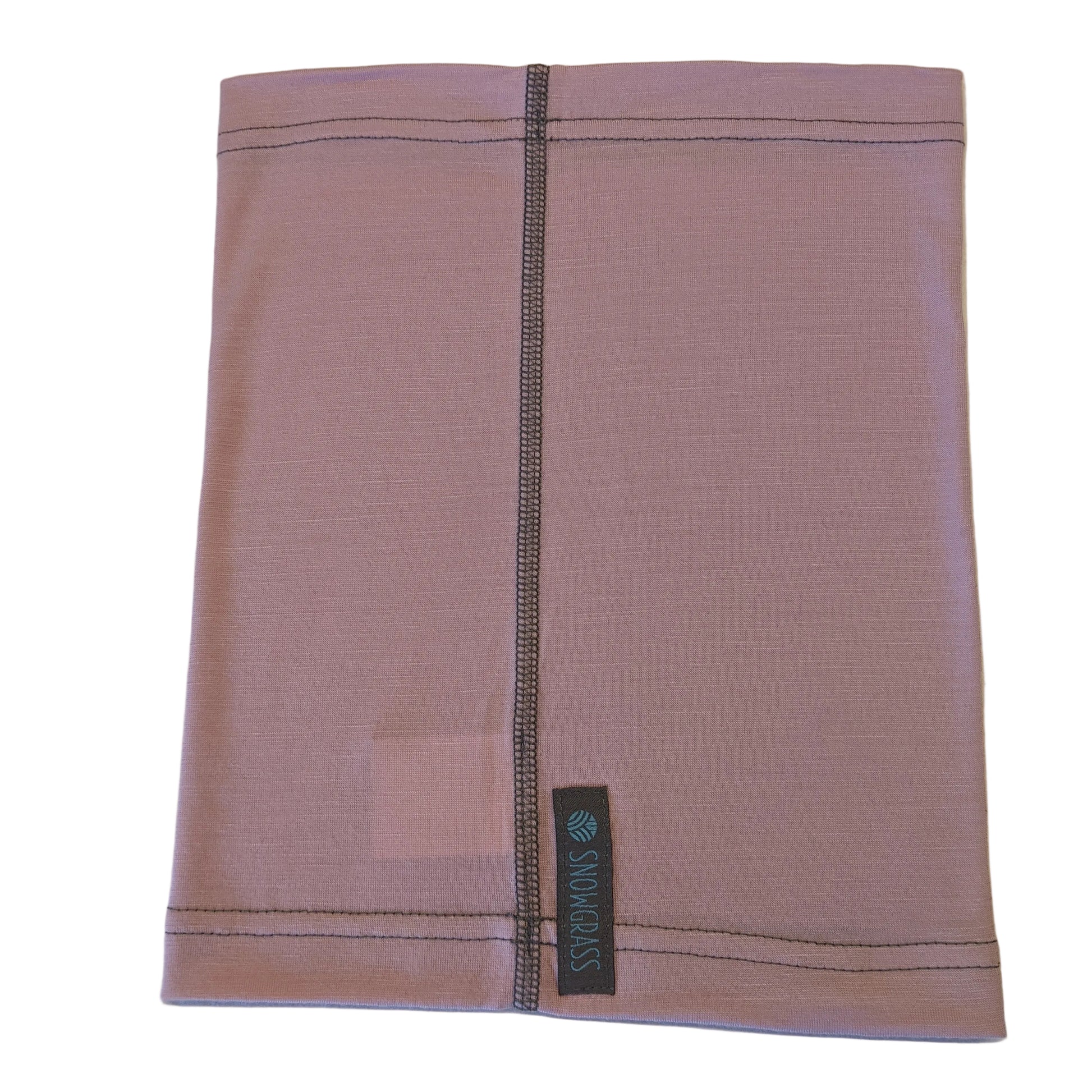 A dusty pink merino wool snood with grey contrast stitching and a brand label reading 'SNOWGRASS'