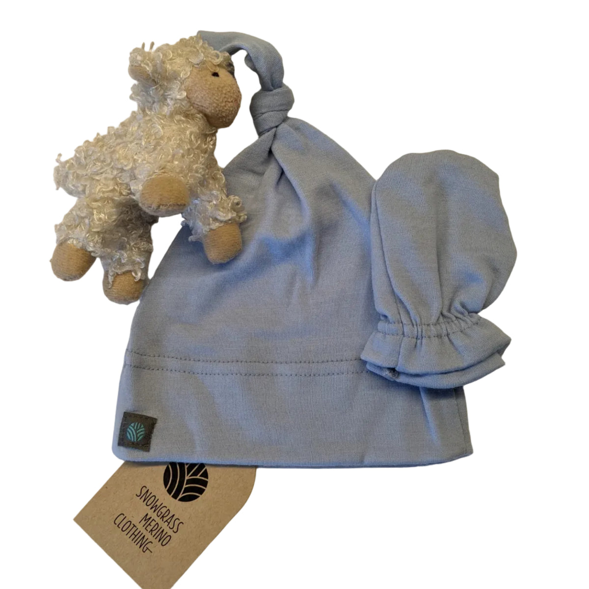 Merino Wool Hat and Mittens for a Newborn baby, shown with a toy sheep and brand tag