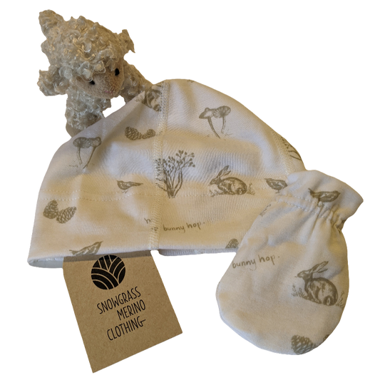 Merino Wool Baby Gift Set of Hat and Mittens with teddy bear and tag on a white background