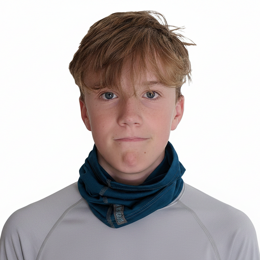A young man with light brown hair wearing a gray long-sleeve shirt and a dark teal Merino Wool neck gaiter, photographed against a solid white background.